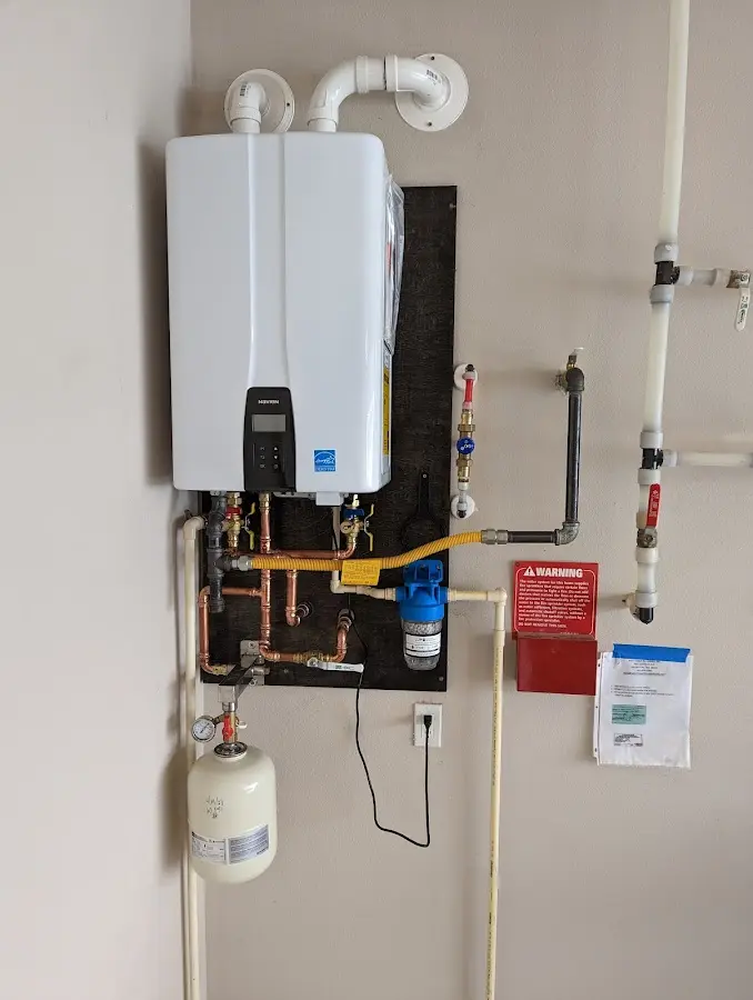 Professional plumber installing copper piping in a Olivarez home